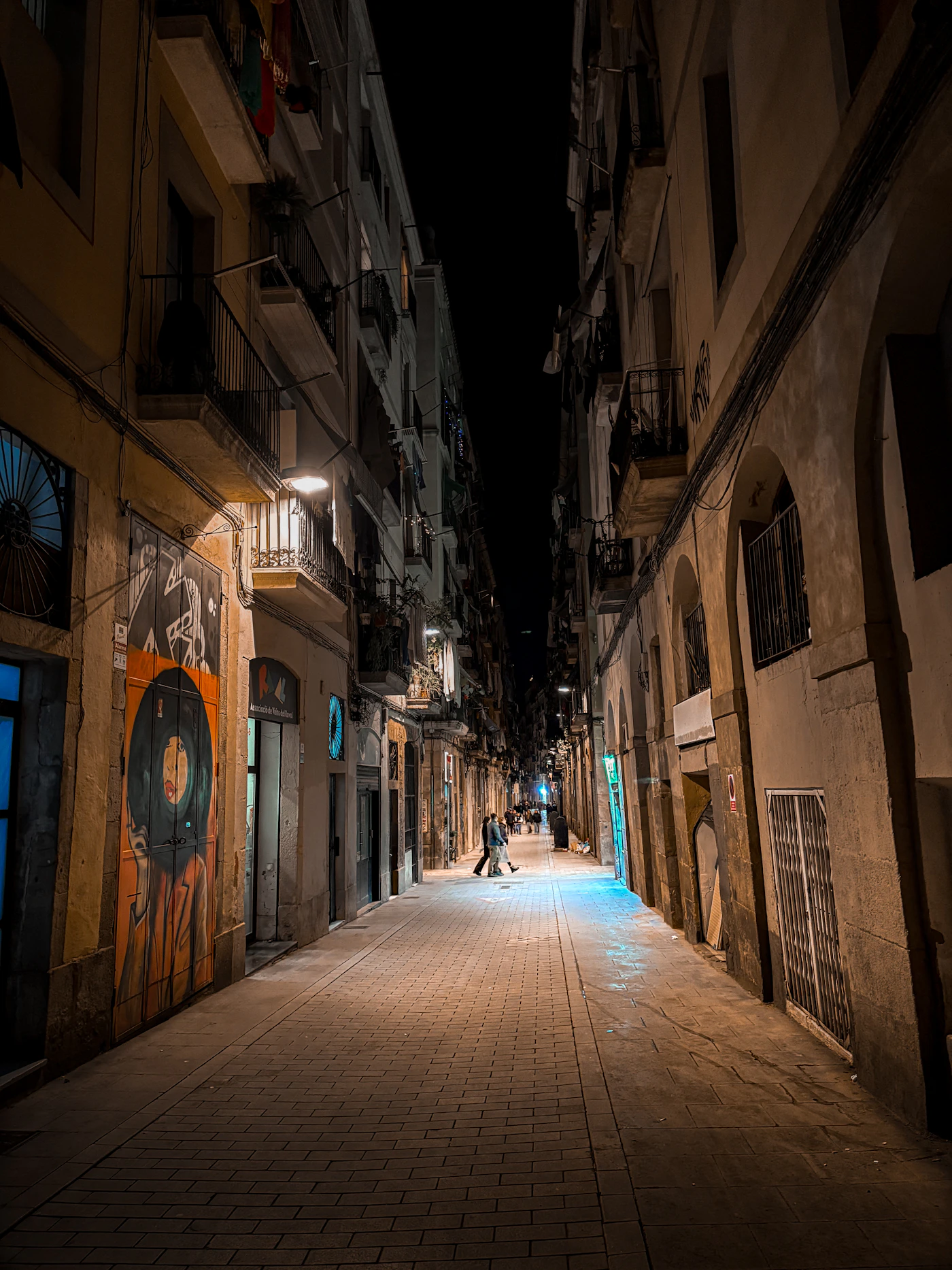 A quiet Barcelona street lit up at night